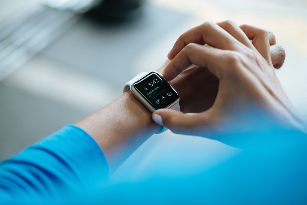 A person wearing a fitness watch while jogging in a park, showcasing an active lifestyle.